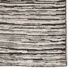 Close-up of plush pile with subtle ridges illustrating depth and variation between dark gray and ivory stripes