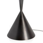 Close-up of lamp's aged brass tapered cone base showing smooth texture