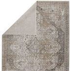 Top corner folded back revealing solid light taupe backing of vintage medallion rug