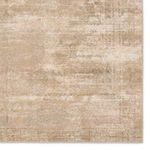 Detailed close-up of vintage pattern and border on the tan and green distressed rug surface