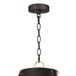 Close-up of blackened chain and round ceiling mount fitting with brass loop attachment on chandelier