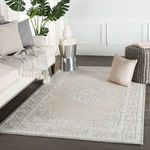 Rug styled in living room with sofa, pillows, side table, and decorative accessories