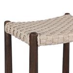 Close-up corner detail of woven seat secured around dark wood frame posts