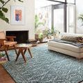 Yeshaia teal/dove rug styled in a bright living room beneath mid-century modern furniture