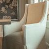 Three-quarter arm and front angle highlighting stitched upholstery details and seat cushion