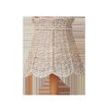Whitewashed seagrass tapered chandelier shade with scalloped bottom edge on a wooden base