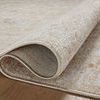 Rug folded back to reveal tightly woven backing and thickness of power-loomed polyester pile