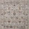 Traditional Lyra Pebble rug with muted watercolor tones, floral motifs, and a distressed soft-beige background