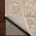 Rug corner flipped up to reveal the stable woven backing in matching neutral tones