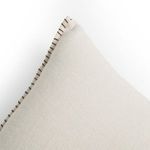 Close-up of pillow corner stitching with visible texture of hemp fabric in natural flax