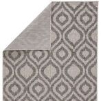 Back side of rug folded over revealing flat weave and consistent gray pattern on reverse