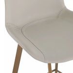 Close-up showing detailed white faux leather seat stitching and curved edges