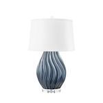 Ceramic table lamp with wavy blue glaze body on clear acrylic base, topped with white drum shade