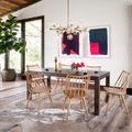 Spacious living room with basket placed on floor beside sofa beneath large windows