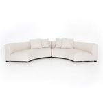 Sectional configured in two curved parts separated to show modularity from a front angle