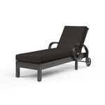 Monterey Chaise Lounge in dark espresso aluminum frame with curled arms and a black cushioned seat and adjustable backrest