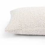 Back side of pillow with visible zipper and looped off-white texture