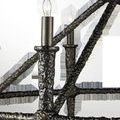 Close-up of Blackthorn Chandelier’s textured aged bronze frame with lit candle-style bulbs