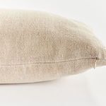 Close-up of beige side highlighting fine weave texture and hidden zipper closure