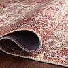 Rolled edge of the rug showing thickness and soft texture on a hardwood floor