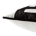 Close-up side angle focusing on texture and curve of black velvet pattern and white piped edge