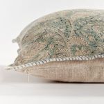 Close-up of the zipper concealed along the pillow's side seam with striped piping and floral fabric