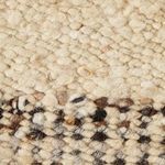 Close-up on textured wool fibers showing looped and knotted weaving technique