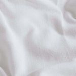 Close-up showing the fine texture and weave of the soft white bamboo linen fabric