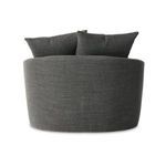 Side angle adjacent to armrest showing rounded seat and fabric weave details