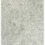 Soft grey shag rug with subtle diamond motifs and fringed edges in a neutral Scandinavian style