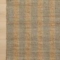 Top corner of rug showing woven texture and clean finished edge against light wood flooring