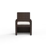 Front view emphasizing rectangular silhouette and contrast of white cushion against brown wicker