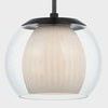 Close-up view of pendant showing detailed fluting on opal interior and aged brass finish
