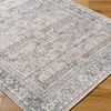 Close-up angled view of the rug showing the detailed woven pattern and its placement on a wood floor.