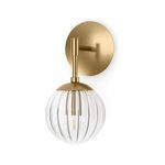 Sunset Sconce mounted with glass globe shade facing downwards and brass arm visible