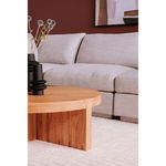 Close side view of Folke coffee table featuring natural wood texture and decorative vases by gray sectional sofa