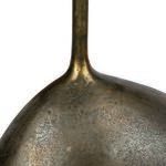Textured surface and curve detail of heavy, asymmetrical bronze base with greenish aged patina