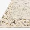 Close-up of textured wool pile and corner detail with geometric border in ivory and lagoon colors