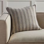 Lucien striped pillow showcased on beige sofa for scale and styling context