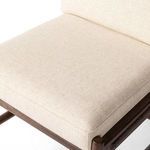 Close-up showing soft linen upholstery on padded seat with visible weave