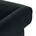 Detailed shot of rounded velvet armrest edge wrapping around wood frame