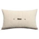 Rectangular cream wool pillow with subtle horizontal stripes, brown embroidered center, and button details