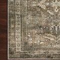 Close-up of rug corner showing detailed floral border and muted moss tones on wooden floor