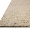 Close-up side angle showing the ribbed texture and edge binding of the Penny Blue natural wool rug