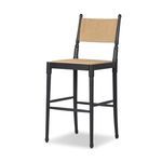 Three-quarter view showing black ash turned legs and square seat frame with paper cord seat