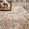Close-up of Wynter rug corner with tray holding books and decorative objects