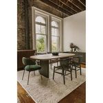 Black Ventana dining chairs paired with modern wooden table in rustic dining room with textured rug