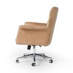 Profile view highlighting chair's padded armrests and leather upholstery with polished aluminum base