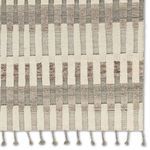 Close-up of braided fringe tassels and ribbed linear details along the rug edge