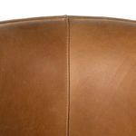 Close-up of upper backrest leather panels joined by a center seam with topstitching